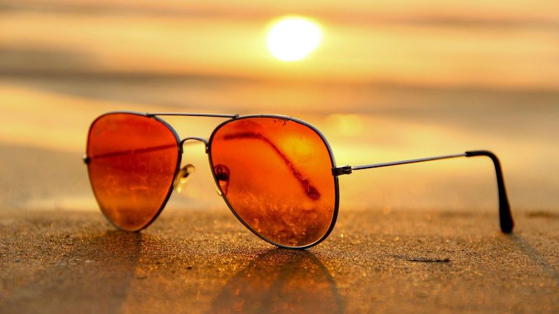 Sunglasses on Beach at Sunset