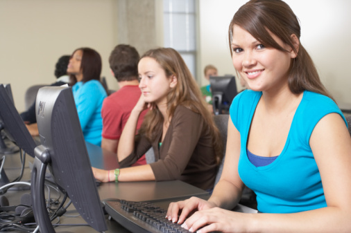 sitting in front of a computer monitor